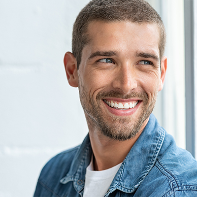 Happy man with a healthy smile looking off into the distance.