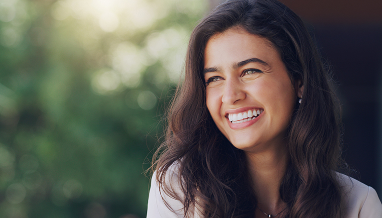Smiling woman enjoying the outdoors with a happy, confident smile.