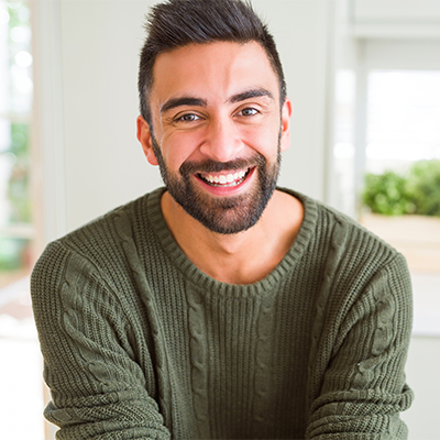 A man smiling with a healthy, natural looking smile.